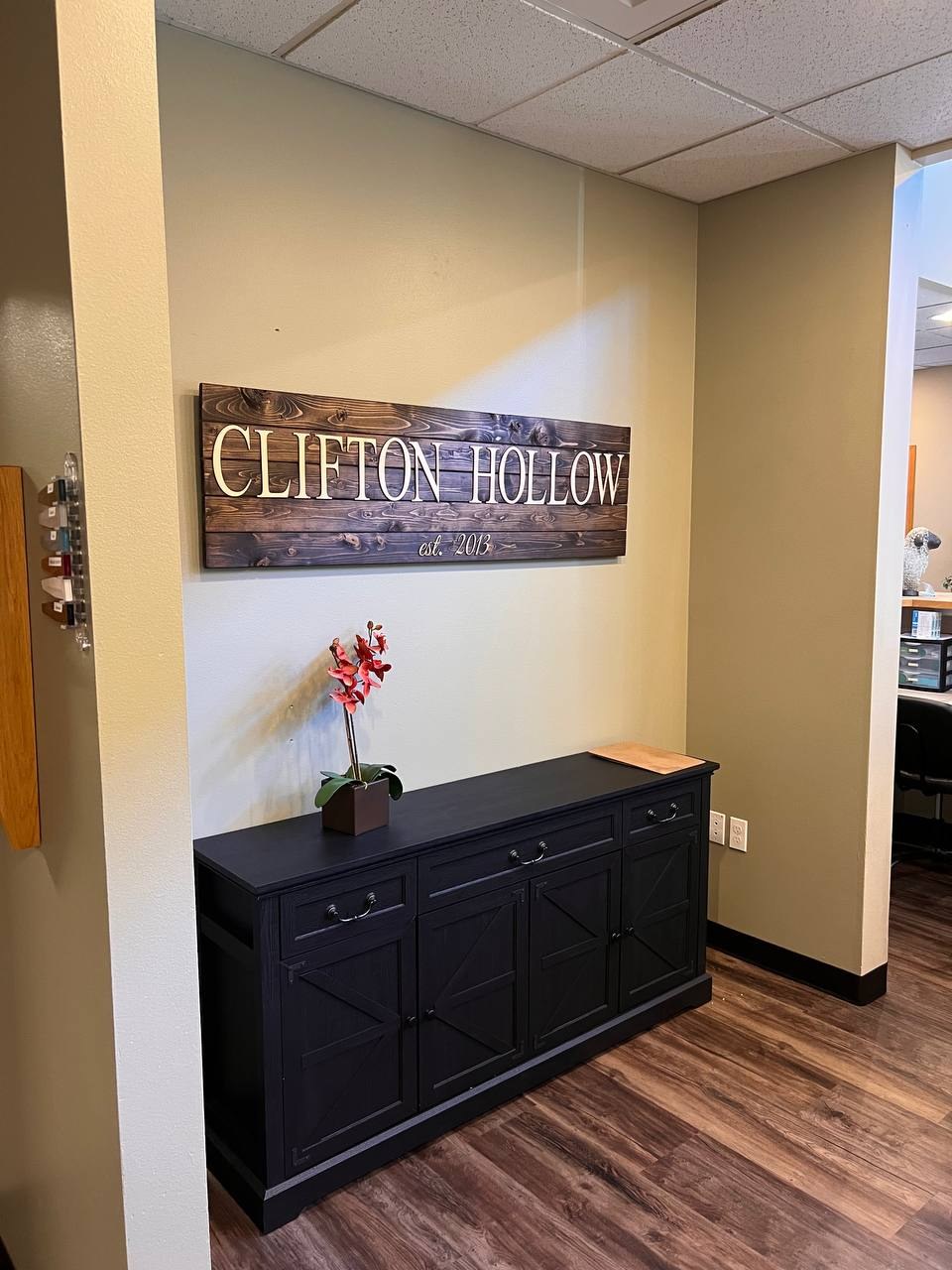 The carved Clifton Hollow wood sign, established 2013, inside the hospital
